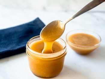 vegan caramel sauce coming off of a spoon